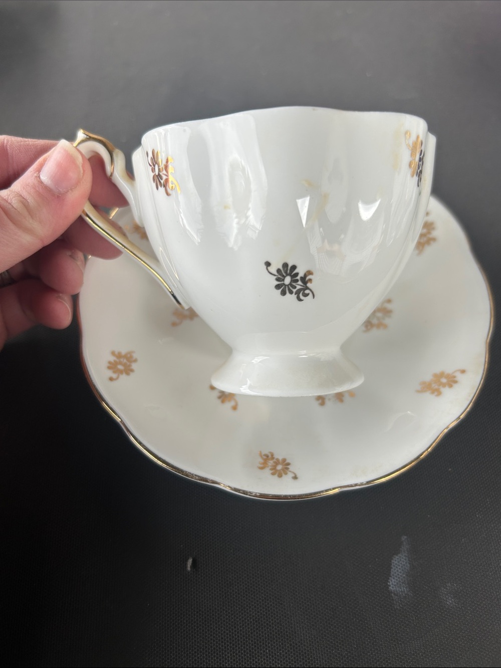 White Porcelain Tea Cup and Saucer with Gold Floral Accents